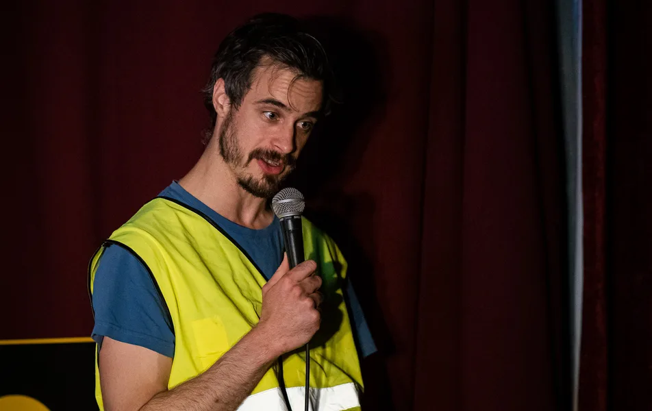 A comedian performing at Soho Comedy Factory's Blue Posts venue on Berwick Street