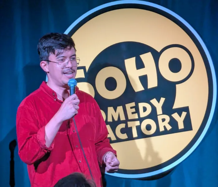A comedian performing at Soho Comedy Factory's Coach House venue